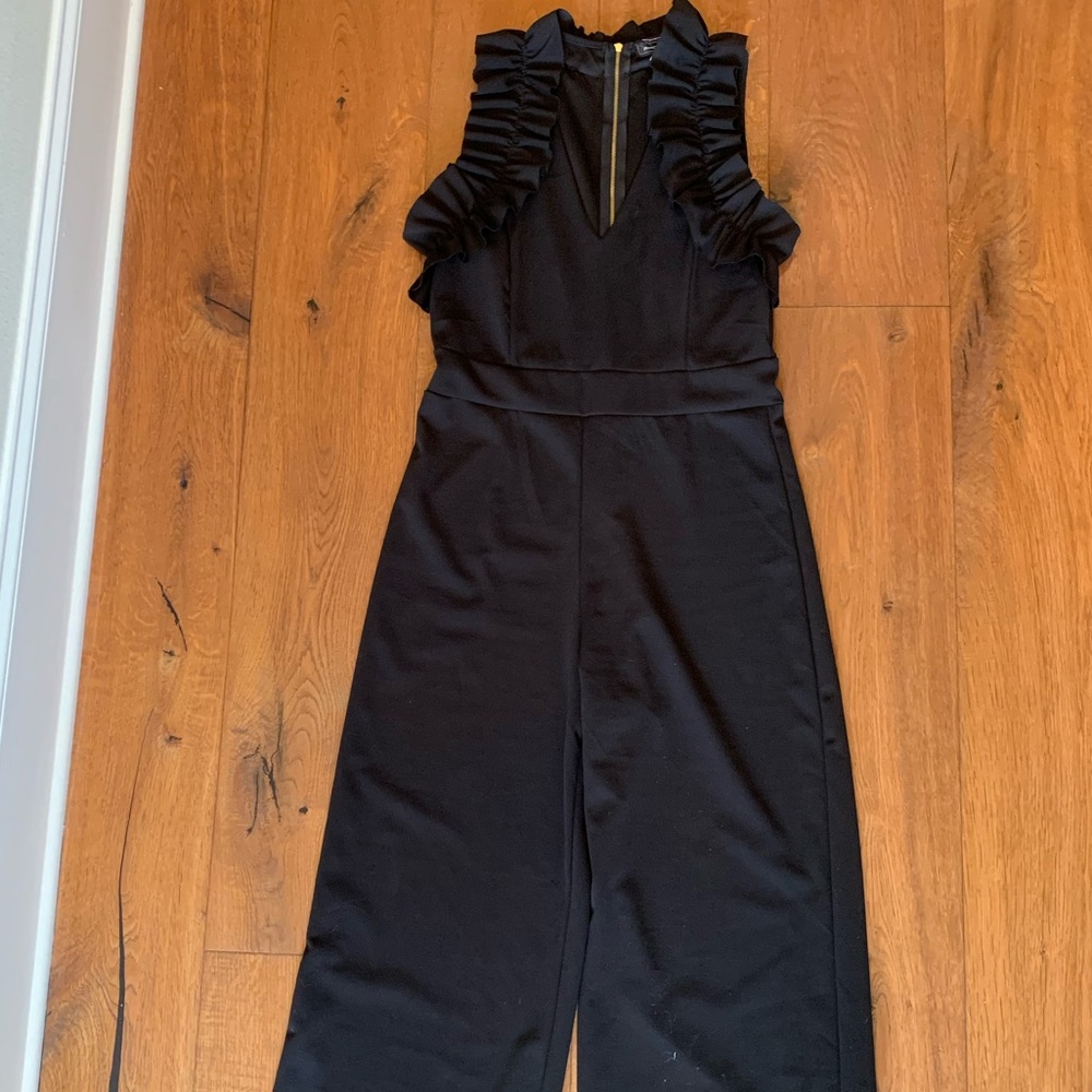 Black jumpsuit with ruffle top and wide legs